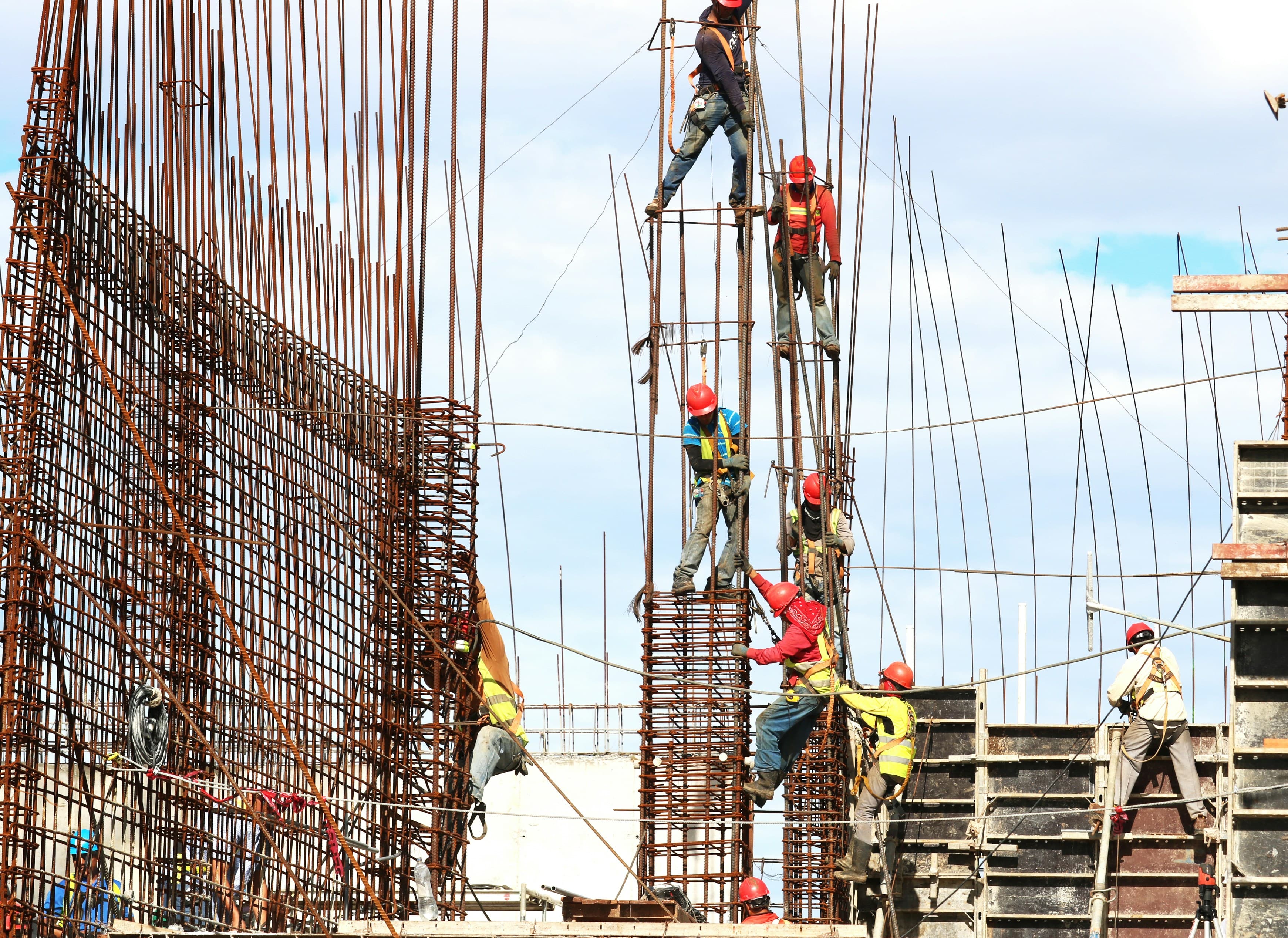 hardhats sitting on desk with construction plans