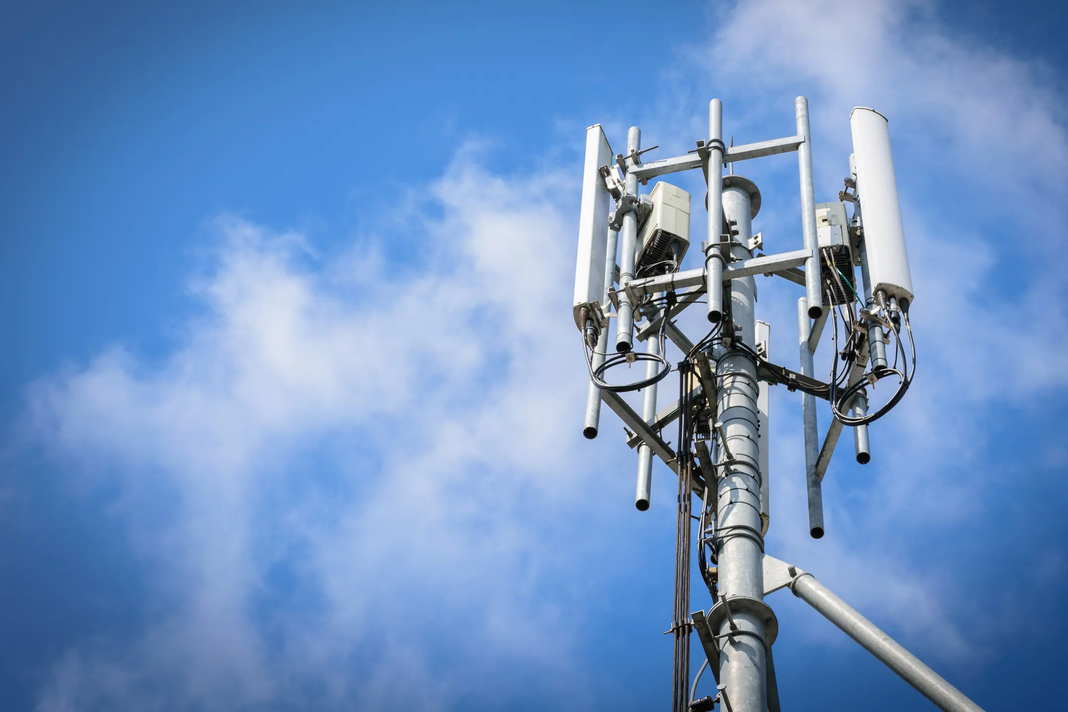 A telecommunications tower against a blue sky