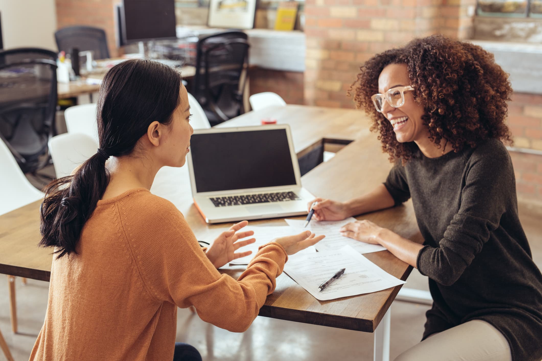 Two people reference a Quickbase app