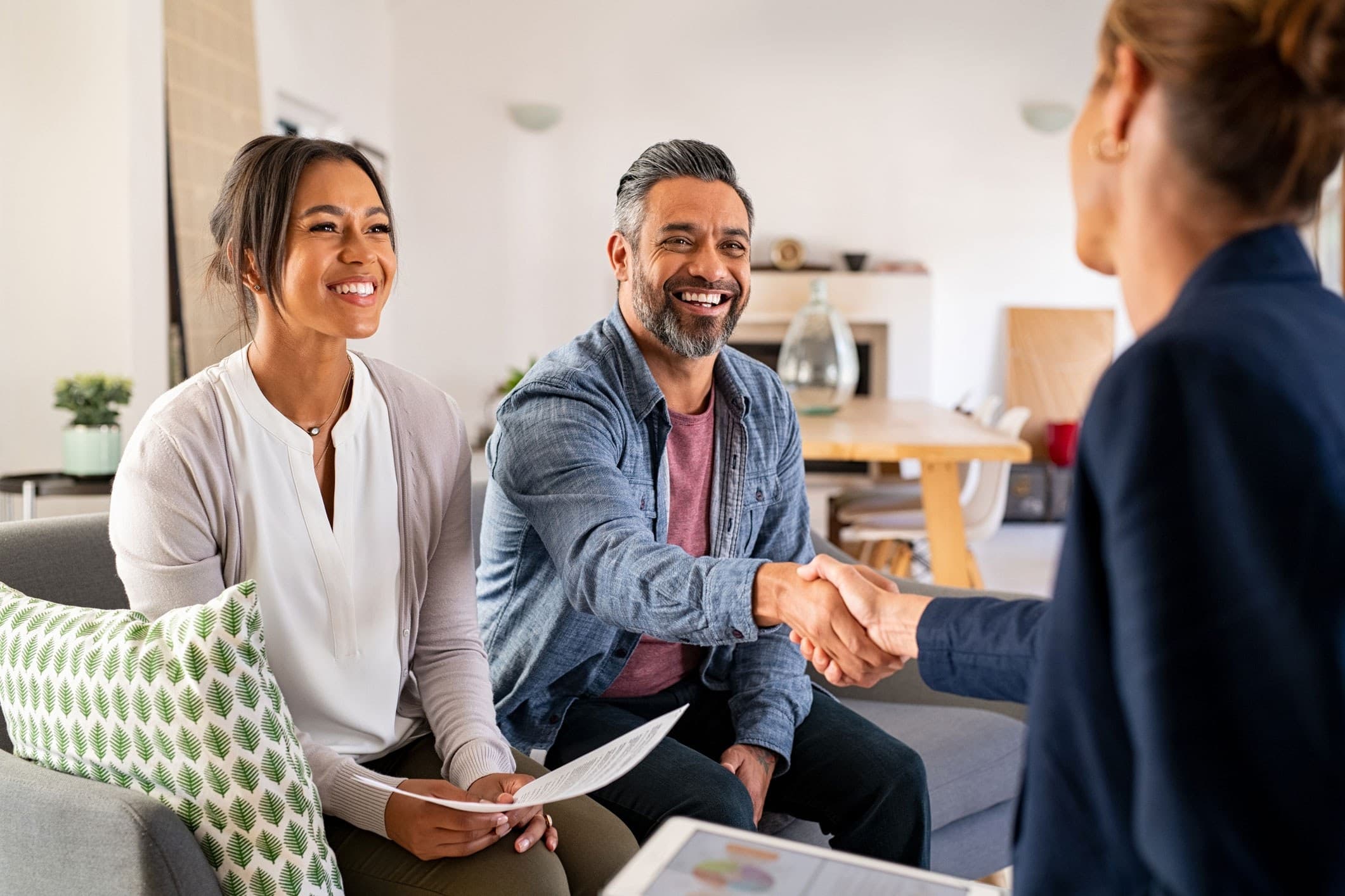 People shake hands after closing a deal