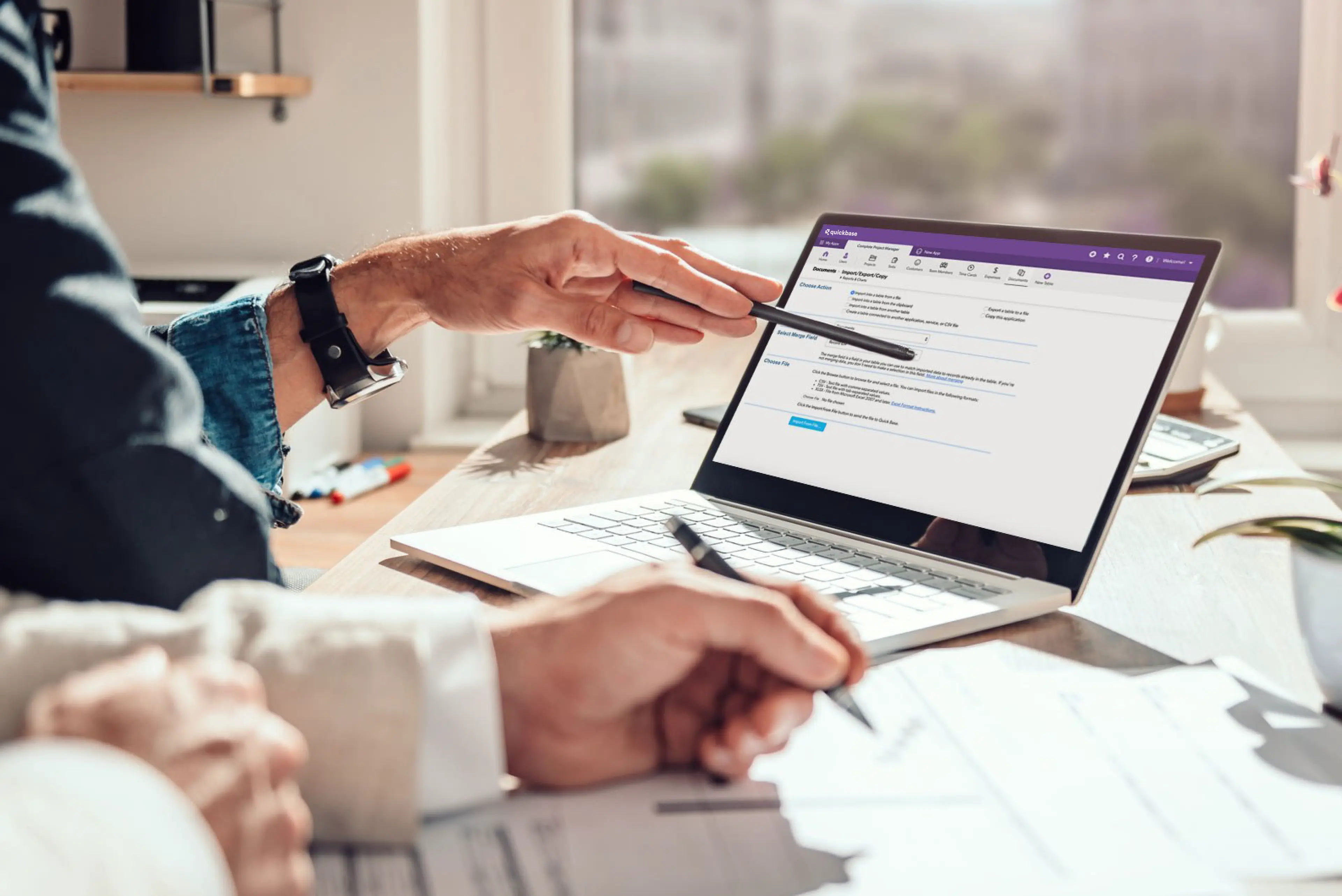 Two people work together to import data to a Quickbase app