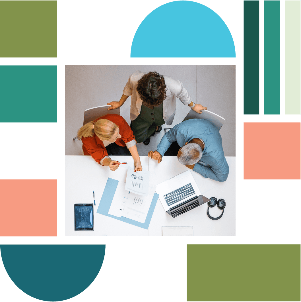 A bird's eye view of people sitting and working around a desk